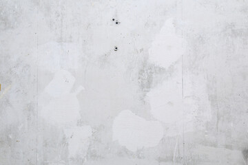 Gray concrete wall peeled of wallpaper. Concrete background.