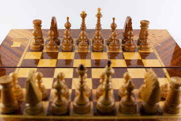 chessboard made of wooden pieces on white