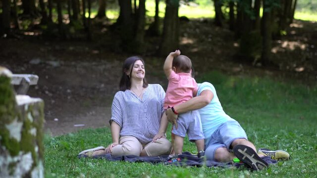 Young family with a child on a picnic in the national park