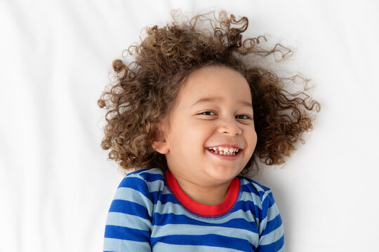 Portrait of happy young boy with curly hair