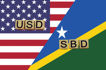 USA and Solomon Islands currencies codes on national flags background