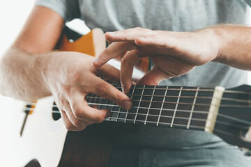 Close-up on the hands of a guitarist playing classical guitar in two handed tapping technique.