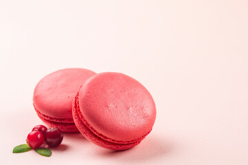 Berry macarons decorated with fresh berries. Copy space.