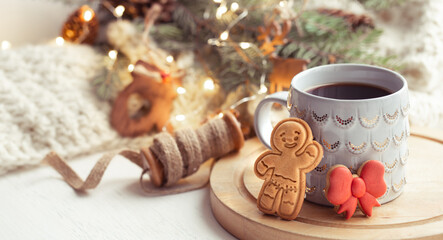 Obraz na płótnie Canvas Christmas composition with gingerbread boy and beautiful cup with hot drink close up.
