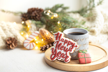 Christmas composition with beautiful cup and gingerbread cookies with happy new year wishes.