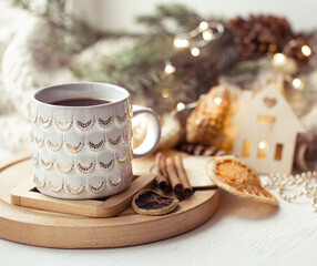 Beautiful cup with hot drink close up on blurred background with bokeh lights.
