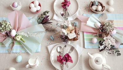 Easter dinner table setting and decor top view.