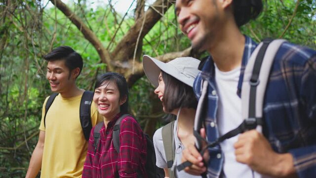 Group of multi ethnicity friend travel through a forest in the summer.