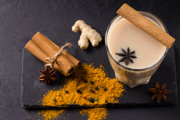 Hot masala tea with spices, cinnamon, ginger and star anise, in glass