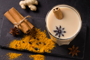 Hot masala tea with spices, cinnamon, ginger and star anise, in glass