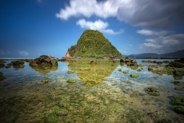 View of Red island beach in Banyuwangi in Indonesia. Java popular travel destination. Summer holiday background.