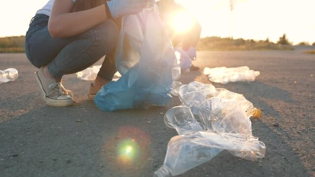 People volunteers in park collect plastic waste. Volunteers sort plastic waste from recycling industry. Environmental pollution, ecological disaster. People care about nature collect plastic waste