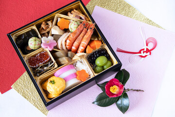 日本の正月　おせち料理と椿の花と和紙と水引