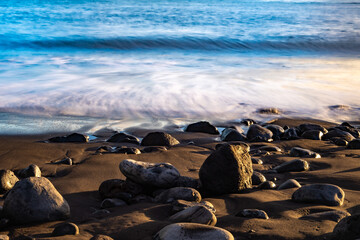 Calm waves touching beach stones on Madeira island