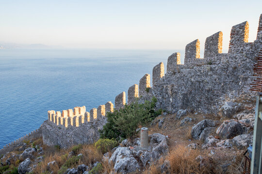 Elements of an ancient fortress. ancient city. Fortress on the rocks. Ruined walls of a medieval castle on the mountain.