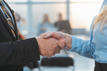 close up. businessman politely shaking hands with a business woman.