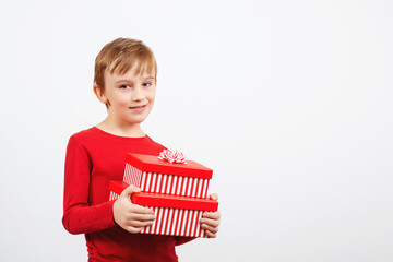 Happy kid holding gift boxes surprise. Happy little boy with presents isolated over white background.