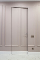 Open invisible hidden door in the wall with boiserie in classic interior with white marble floor