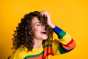 Photo of funny positive woman dressed casual colorful pullover closed eyes arm head isolated yellow...