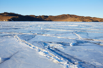 Fototapeta na wymiar Beautiful landscape of frozen Lake Baikal. Small Sea Strait in winter sunny frosty winter day.