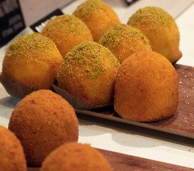 typical Sicilian recipe called Arancino, a delicacy based on fried rice, melted cheese and pistachio cream