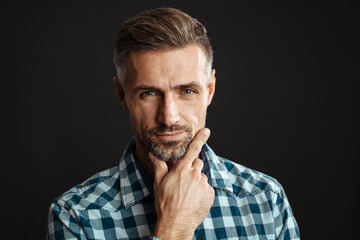 Masculine confident man posing and looking at camera