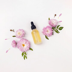 Composition with face serum or essential oil and flowers