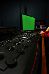 Men edit videos in a dark studio using modern color grading tools and equipment.Selective...