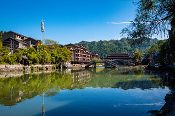 Fototapeta premium the river, the boat, stone bridge and the old houses at ancient phoenix town in the morning at Hunan, China.