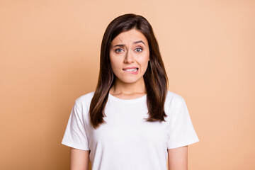 Photo portrait of worried nervous young woman biting lip worried in casual clothes isolated pastel...