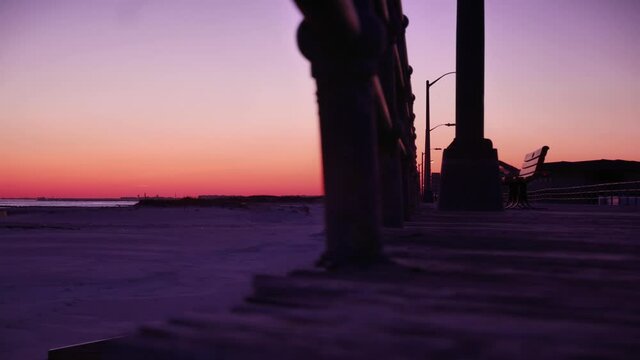 Long Beach, New York - February 28, 2014 - Panoramic Timelapse of the deserted boardwalk and beach at sunset.