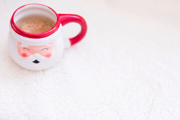 Ceramic santa cup of christmas coffee with cinnamon