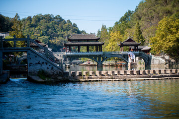 Fototapeta na wymiar ourists walking along Phoenix Ancient Town (Fenghuang County). Awesome view of scenic old street. Fenghuang is a popular tourist destination of Asia.