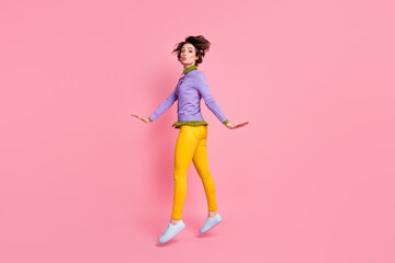 Fototapeta na wymiar Full length profile photo of funny lady jump up sending air kisses wear jumper pants shoes isolated pink color background