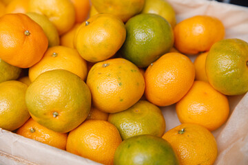  Fresh mandarins on fruit market, close up. Boxes full of ripe mandarin oranges for sale on farmers market. Fresh fruit display in shop. Juicy mandarin orange at the greengrocer's stall.