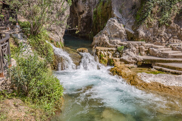 Park of waterfalls with green clean water ponds (Toll del Baladre, Las Fuentes del Algar / Algar fountains, Callosa de Ensarria) Alicante province, Spain.