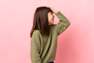 Little girl isolated on pink background has realized something and intending the solution