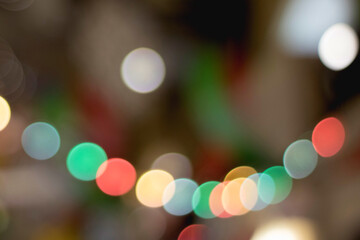 Multicolored bokeh circles on a dark background.