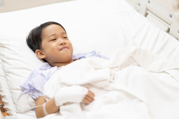 Obraz na płótnie Canvas A patient boy is a sick flu in the hospital, He has a cheerful heart.