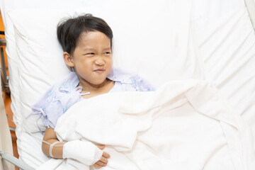 A patient boy is a sick flu in the hospital, He has a cheerful heart.