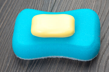 bath sponge and soap on wooden background