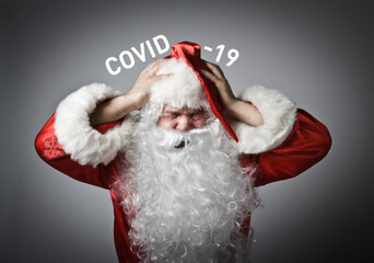 Frustrated Santa Claus, he is full of doubts and hesitation. Concept about coronavirus outbreak....
