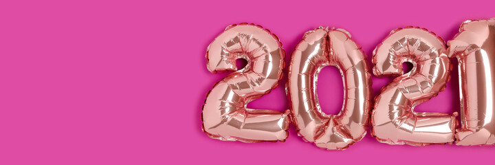 Header with 2021 made from rose gold color balloons on a magenta background with place for your...