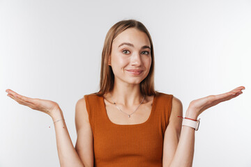 Fototapeta premium Pleased beautiful woman smiling and holding copyspace