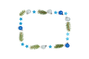 Frame made of Christmas decor and spruce branches on a white background. Festive flatlay with place for text.