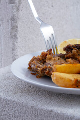 real meat schnitzel and potatoes. Lemon and sauce.