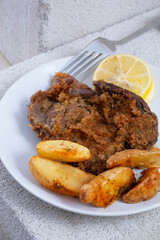 real meat schnitzel and potatoes. Lemon and sauce.