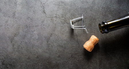 Wine, glasses and corkscrew over stone background. Top view with copy space