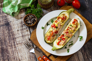 Healthy food. Baked zucchini stuffed with meat and tomatoes on rustic wooden table. Copy space.