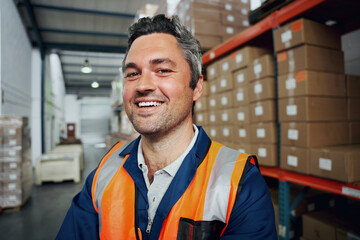 Close up of a happy factory worker with industrial background